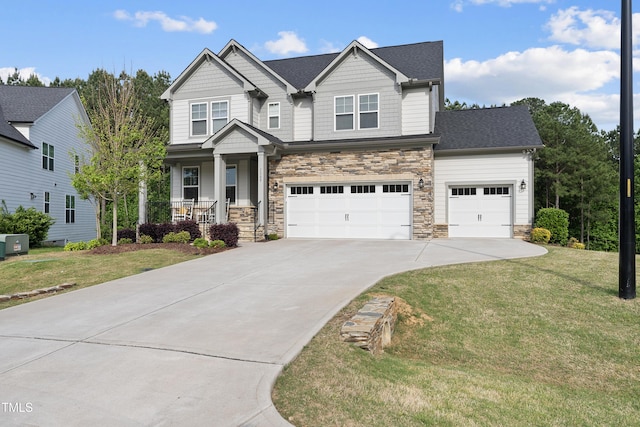 craftsman-style house featuring concrete driveway, covered porch, stone siding, and a front lawn