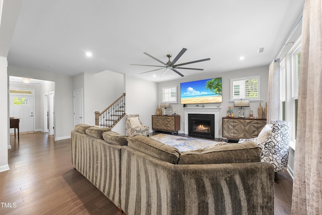 living room with a ceiling fan, baseboards, recessed lighting, hardwood / wood-style flooring, and a fireplace with flush hearth