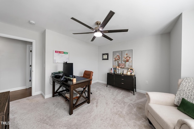 home office with baseboards, carpet flooring, and a ceiling fan