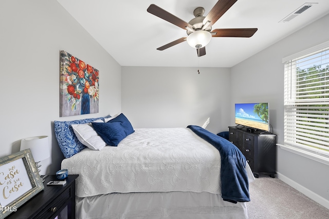 bedroom with baseboards, visible vents, ceiling fan, and carpet