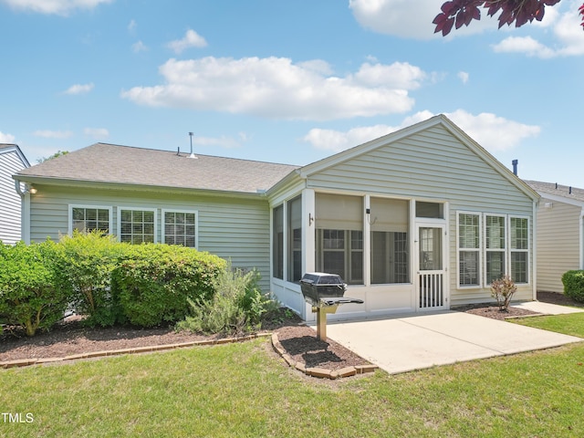 519 Garendon Dr, Cary, NC 27519 - rear view of house featuring a yard, a patio, a shingled roof, and a sunroom