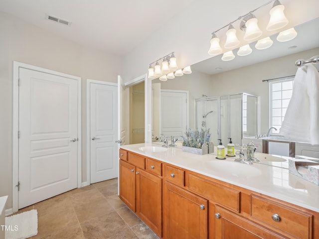 519 Garendon Dr, Cary, NC 27519 - bathroom featuring a sink, a stall shower, double vanity, and visible vents