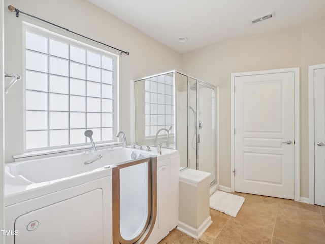 519 Garendon Dr, Cary, NC 27519 - bathroom with visible vents, a shower stall, a tub, and washing machine and clothes dryer