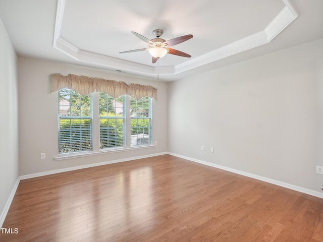 519 Garendon Dr, Cary, NC 27519 - empty room featuring crown molding, ceiling fan, wood finished floors, and a raised ceiling