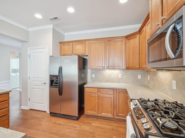 519 Garendon Dr, Cary, NC 27519 - kitchen featuring visible vents, ornamental molding, light wood-type flooring, light countertops, and appliances with stainless steel finishes