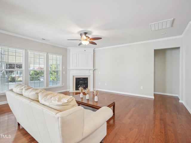 519 Garendon Dr, Cary, NC 27519 - living area featuring visible vents, crown molding, wood finished floors, a fireplace, and ceiling fan