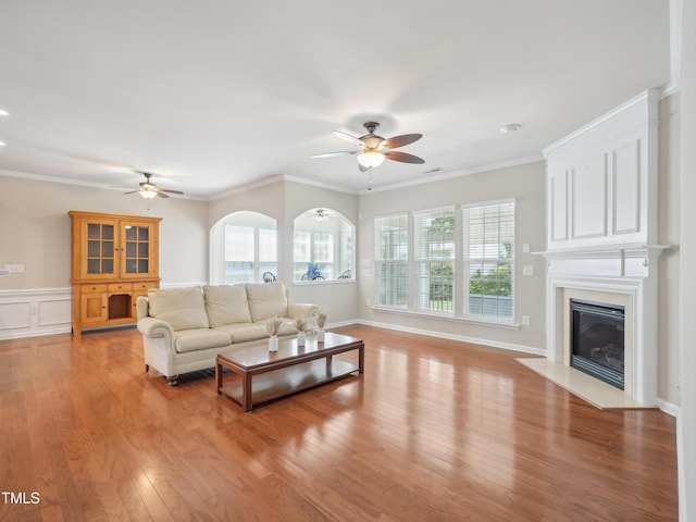 519 Garendon Dr, Cary, NC 27519 - living area featuring ornamental molding, ceiling fan, a fireplace, and light wood-type flooring