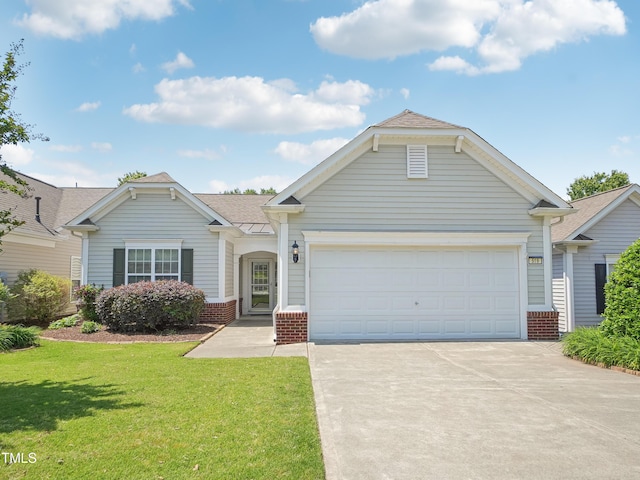 519 Garendon Dr, Cary, NC 27519 - view of front of home with a garage, a front lawn, roof with shingles, brick siding, and driveway