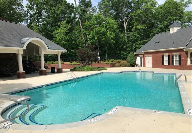 community pool with a patio area