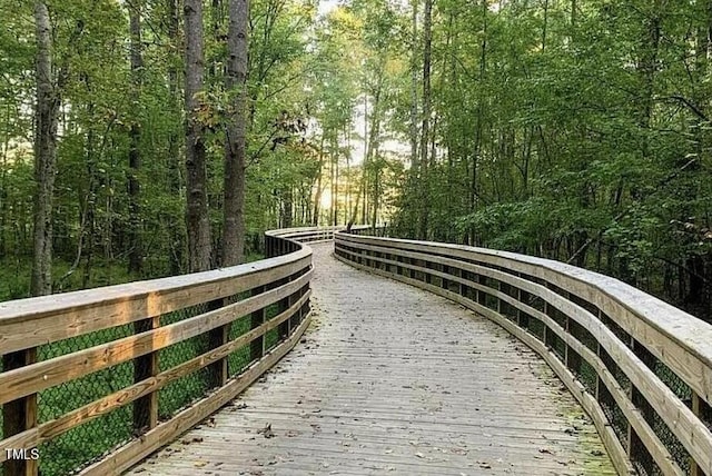 view of community featuring a wooded view and a deck