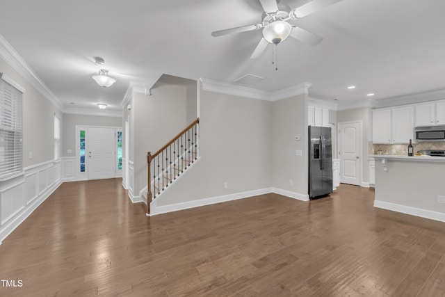 unfurnished living room featuring stairway, crown molding, recessed lighting, dark wood-type flooring, and a ceiling fan