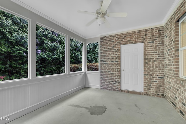 unfurnished sunroom featuring ceiling fan