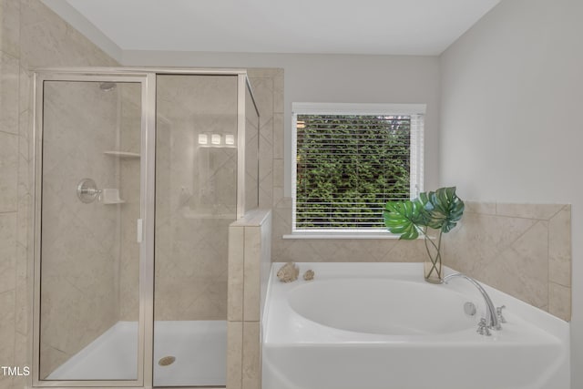 bathroom with a bath and a stall shower