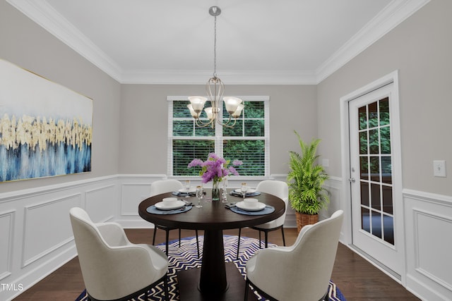 dining space featuring healthy amount of natural light, crown molding, a chandelier, dark wood finished floors, and a decorative wall