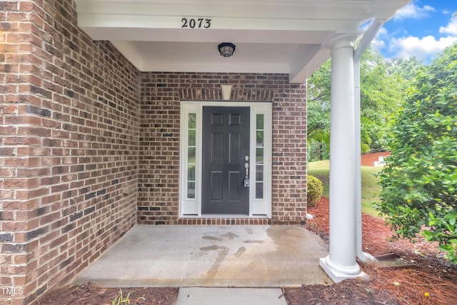 property entrance with brick siding