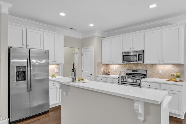 kitchen featuring stainless steel appliances, light countertops, dark wood finished floors, white cabinetry, and recessed lighting