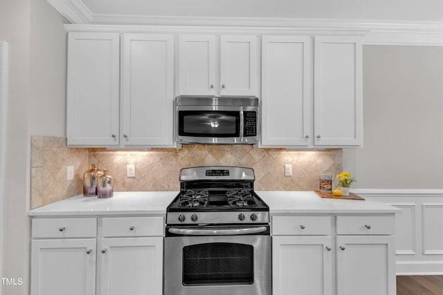 kitchen with appliances with stainless steel finishes, white cabinets, light countertops, and tasteful backsplash