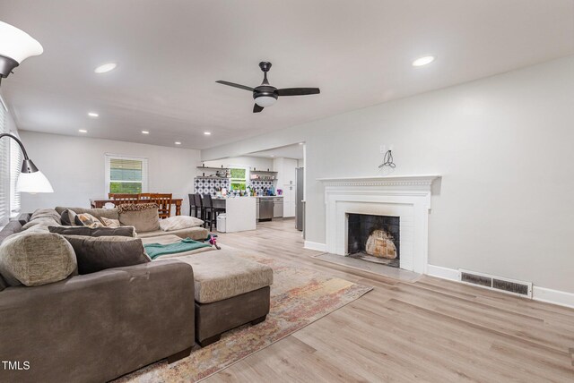 2522 N Roxboro St, Durham, NC 27704 - living room featuring a ceiling fan, light wood finished floors, recessed lighting, a fireplace, and baseboards
