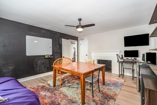 2522 N Roxboro St, Durham, NC 27704 - dining room with a brick fireplace, ceiling fan, and light wood-type flooring