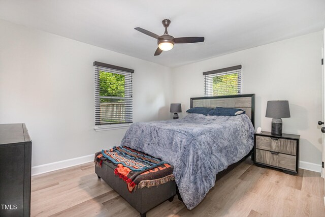 2522 N Roxboro St, Durham, NC 27704 - bedroom with wood finished floors, baseboards, and ceiling fan