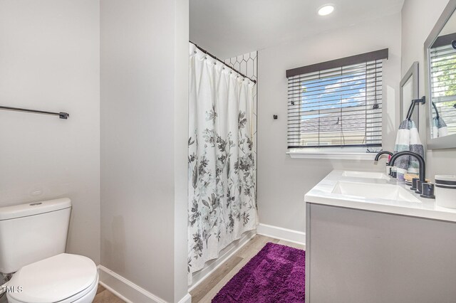 2522 N Roxboro St, Durham, NC 27704 - full bath featuring toilet, baseboards, wood finished floors, vanity, and curtained shower