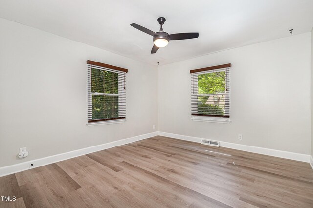 2522 N Roxboro St, Durham, NC 27704 - spare room featuring wood finished floors, baseboards, ceiling fan, and a pendent fire sprinkler