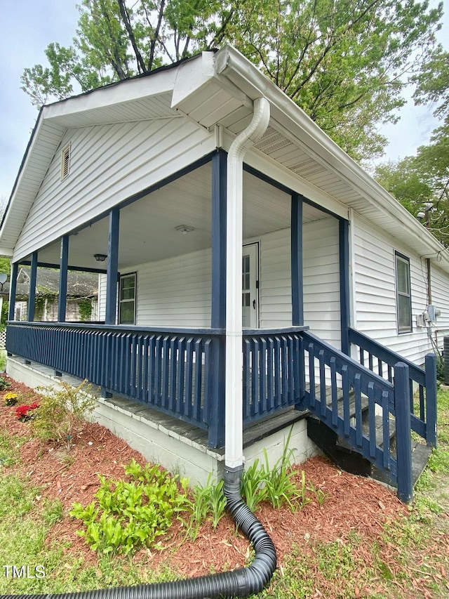 view of side of property with covered porch