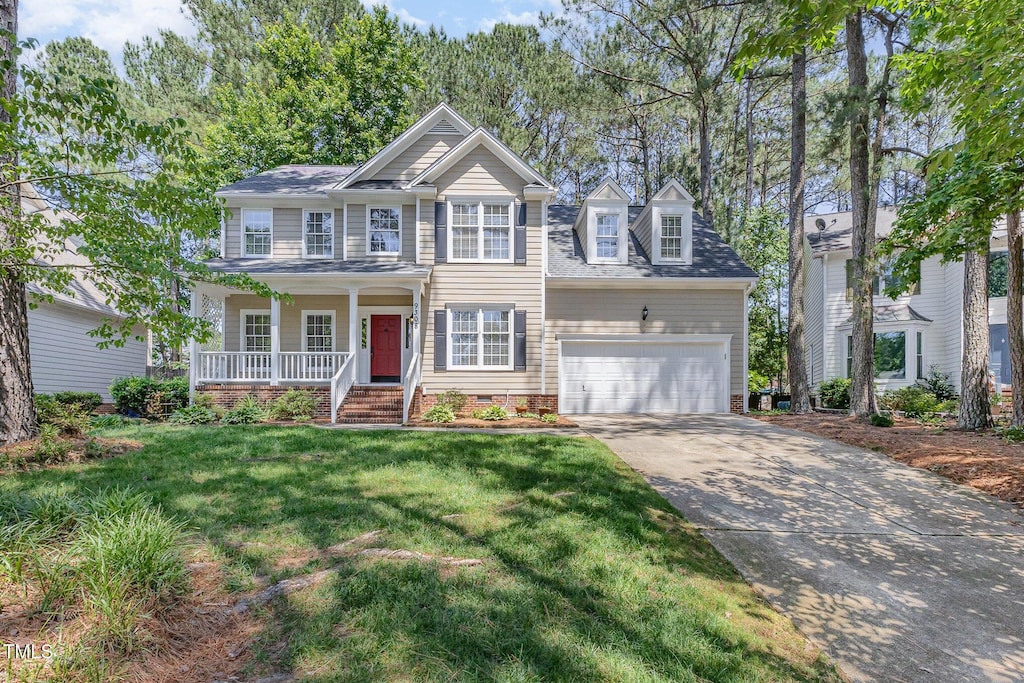 9308 Carisbrook Ct, Raleigh, NC 27615 - view of front of house with a porch, concrete driveway, a front lawn, an attached garage, and crawl space