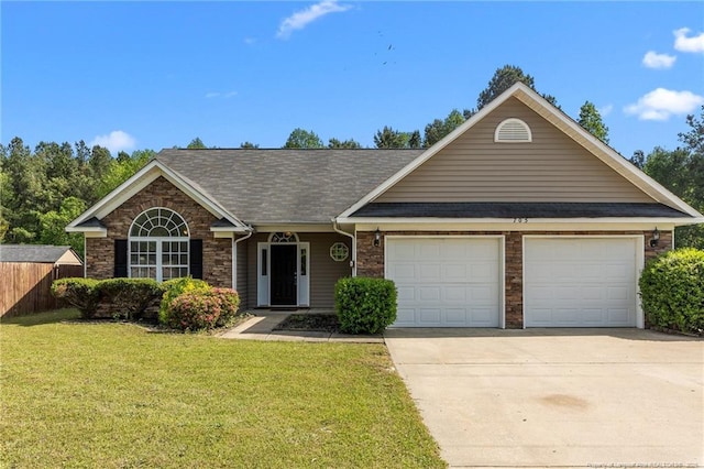 705 Fairfield Cir, Raeford, NC 28376 - view of front of property with an attached garage, driveway, and a shingled roof