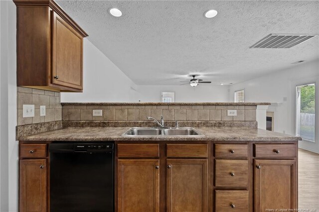 705 Fairfield Cir, Raeford, NC 28376 - kitchen with black dishwasher, a sink, a textured ceiling, a ceiling fan, and backsplash