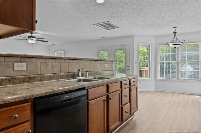 705 Fairfield Cir, Raeford, NC 28376 - kitchen featuring dishwasher, a sink, light wood-style floors, tasteful backsplash, and brown cabinetry