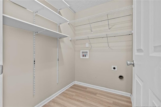 705 Fairfield Cir, Raeford, NC 28376 - clothes washing area with hookup for a washing machine, wood finished floors, baseboards, and hookup for an electric dryer