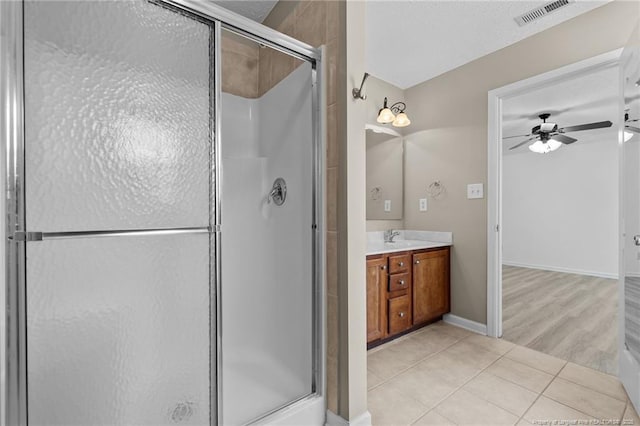 705 Fairfield Cir, Raeford, NC 28376 - full bathroom featuring a stall shower, ceiling fan, tile patterned floors, vanity, and baseboards