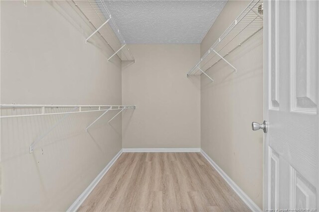 705 Fairfield Cir, Raeford, NC 28376 - walk in closet with wood finished floors