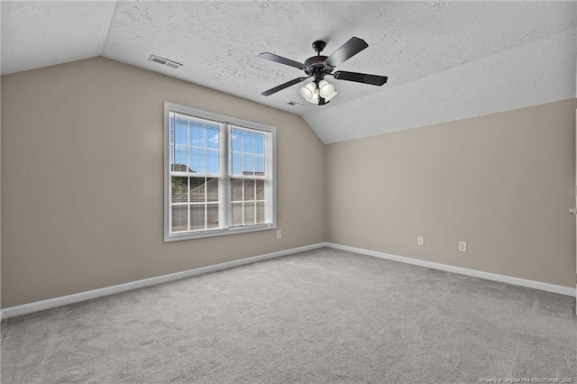 705 Fairfield Cir, Raeford, NC 28376 - empty room with vaulted ceiling, a textured ceiling, carpet flooring, and baseboards