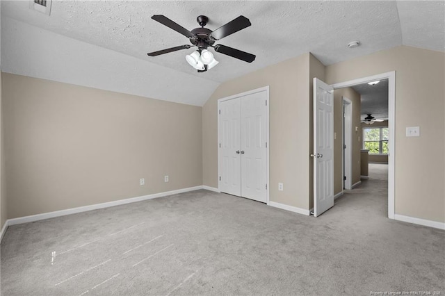 705 Fairfield Cir, Raeford, NC 28376 - unfurnished bedroom featuring vaulted ceiling, carpet flooring, a textured ceiling, baseboards, and a closet