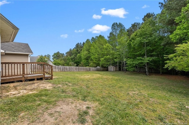 705 Fairfield Cir, Raeford, NC 28376 - view of yard featuring a storage unit, a wooden deck, and an outdoor structure
