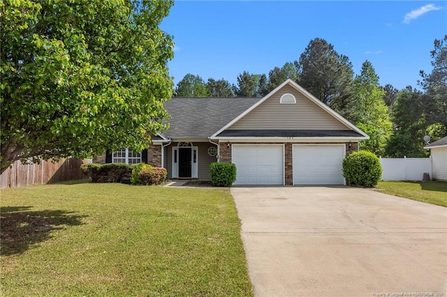 705 Fairfield Cir, Raeford, NC 28376 - view of front facade featuring an attached garage, driveway, brick siding, and roof with shingles