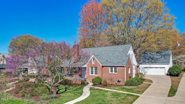 view of front of home featuring concrete driveway, a front yard, brick siding, and a garage