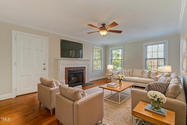 living area featuring crown molding, a ceiling fan, and wood finished floors