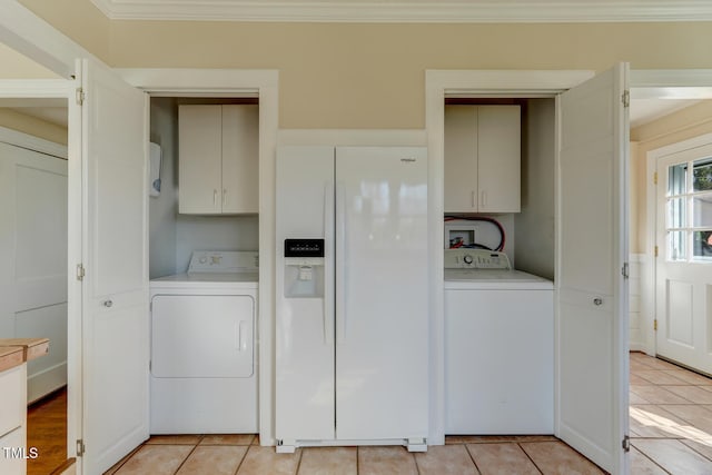 laundry room with light tile patterned flooring, washer hookup, ornamental molding, and cabinet space