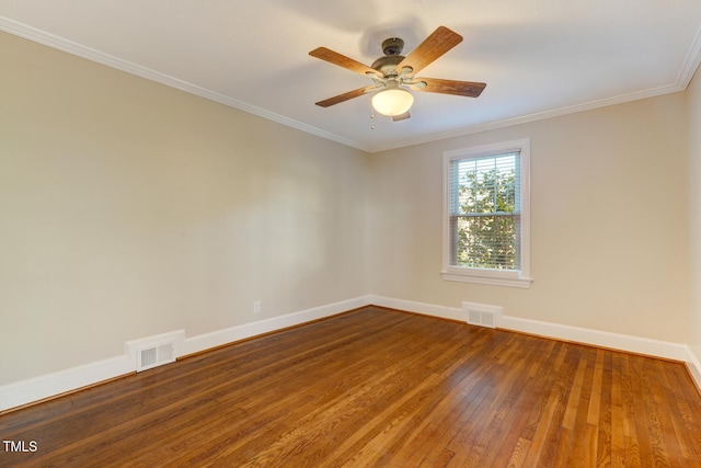 spare room with visible vents, baseboards, and wood finished floors