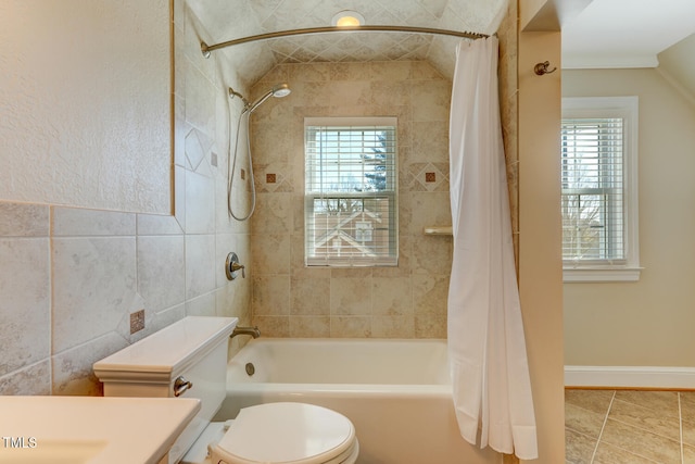 bathroom featuring toilet, tile patterned floors, shower / tub combo with curtain, and a wealth of natural light
