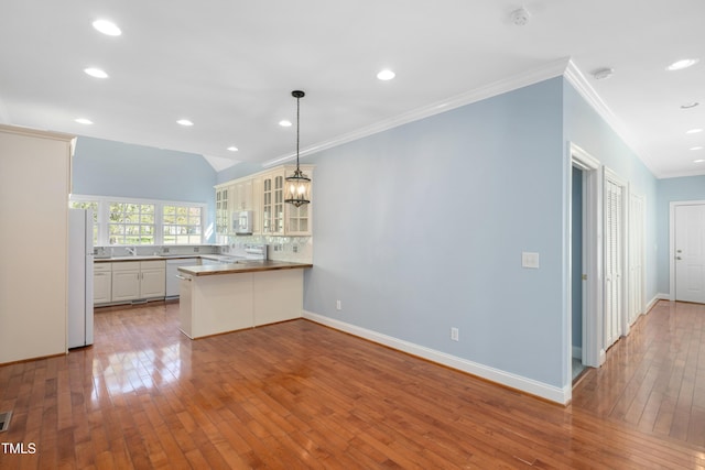 2420 Mollynick Ln, Wake Forest, NC 27587 - kitchen with white appliances, crown molding, a peninsula, glass insert cabinets, and hardwood / wood-style floors