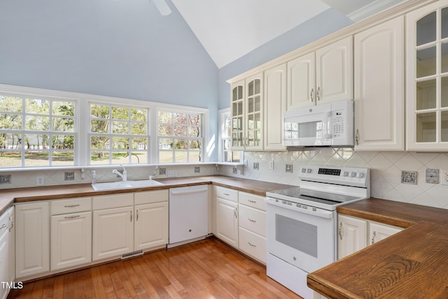 2420 Mollynick Ln, Wake Forest, NC 27587 - kitchen with white appliances, a sink, backsplash, light wood-type flooring, and glass insert cabinets