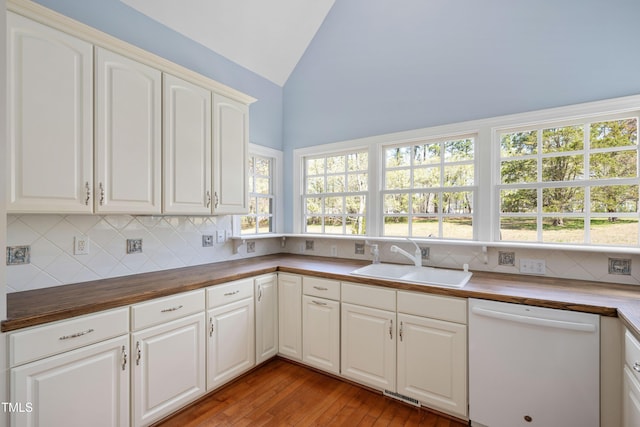 2420 Mollynick Ln, Wake Forest, NC 27587 - kitchen featuring wood counters, dishwasher, a sink, lofted ceiling, and decorative backsplash