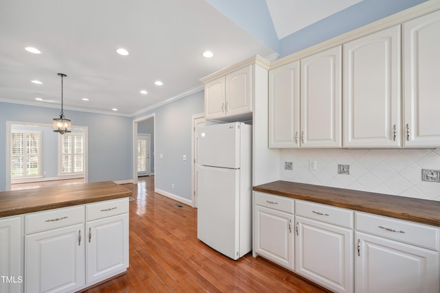 2420 Mollynick Ln, Wake Forest, NC 27587 - kitchen with freestanding refrigerator, butcher block countertops, tasteful backsplash, crown molding, and light wood-style flooring