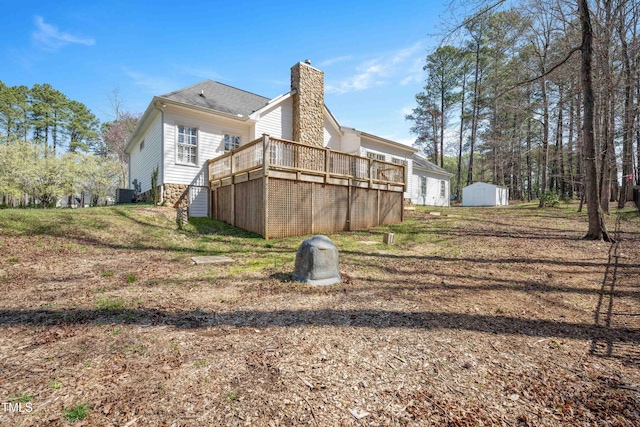 2420 Mollynick Ln, Wake Forest, NC 27587 - rear view of house featuring central AC, a chimney, and a deck