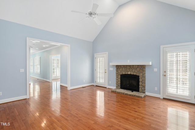 2420 Mollynick Ln, Wake Forest, NC 27587 - unfurnished living room featuring high vaulted ceiling, a ceiling fan, light wood-style floors, baseboards, and a stone fireplace