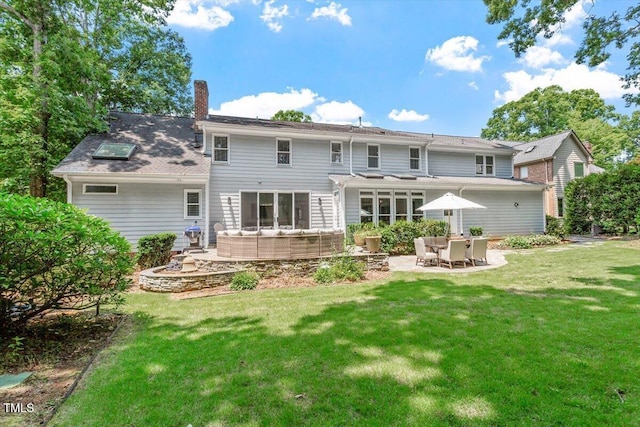 300 Bordeaux Ln, Cary, NC 27511 - back of property with a patio, a chimney, a yard, and an outdoor hangout area